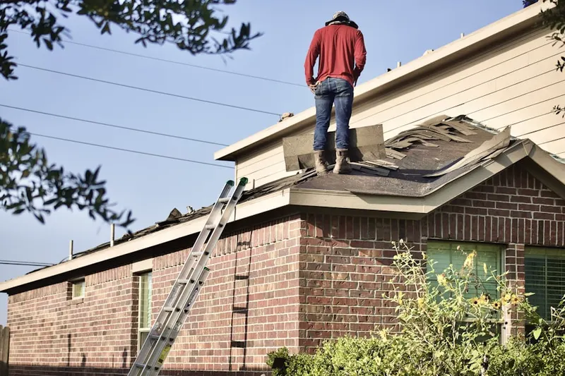 Professional roofer working on a residential roof in Far-A-Field